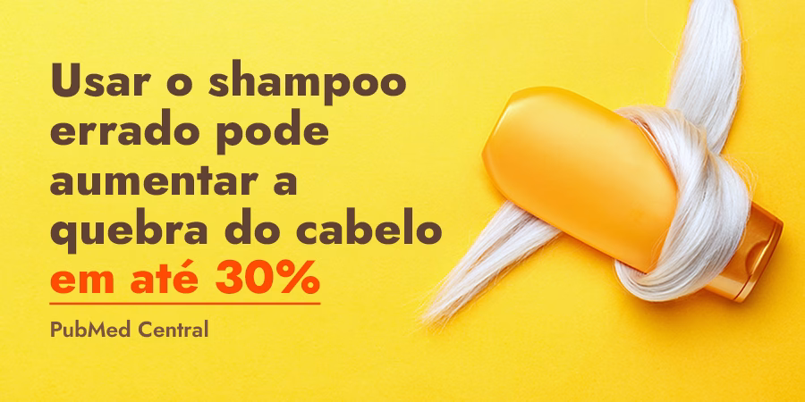 Como fazer o cabelo crescer mais rápido: А Dicas de crescimento de cabelo - Shampoo bottle wrapped in lock of blonde hair on orange color background Gold bottle shampoo in dyed hair strand Hair care cosmetics bath beauty products hair treatment Top view copy space